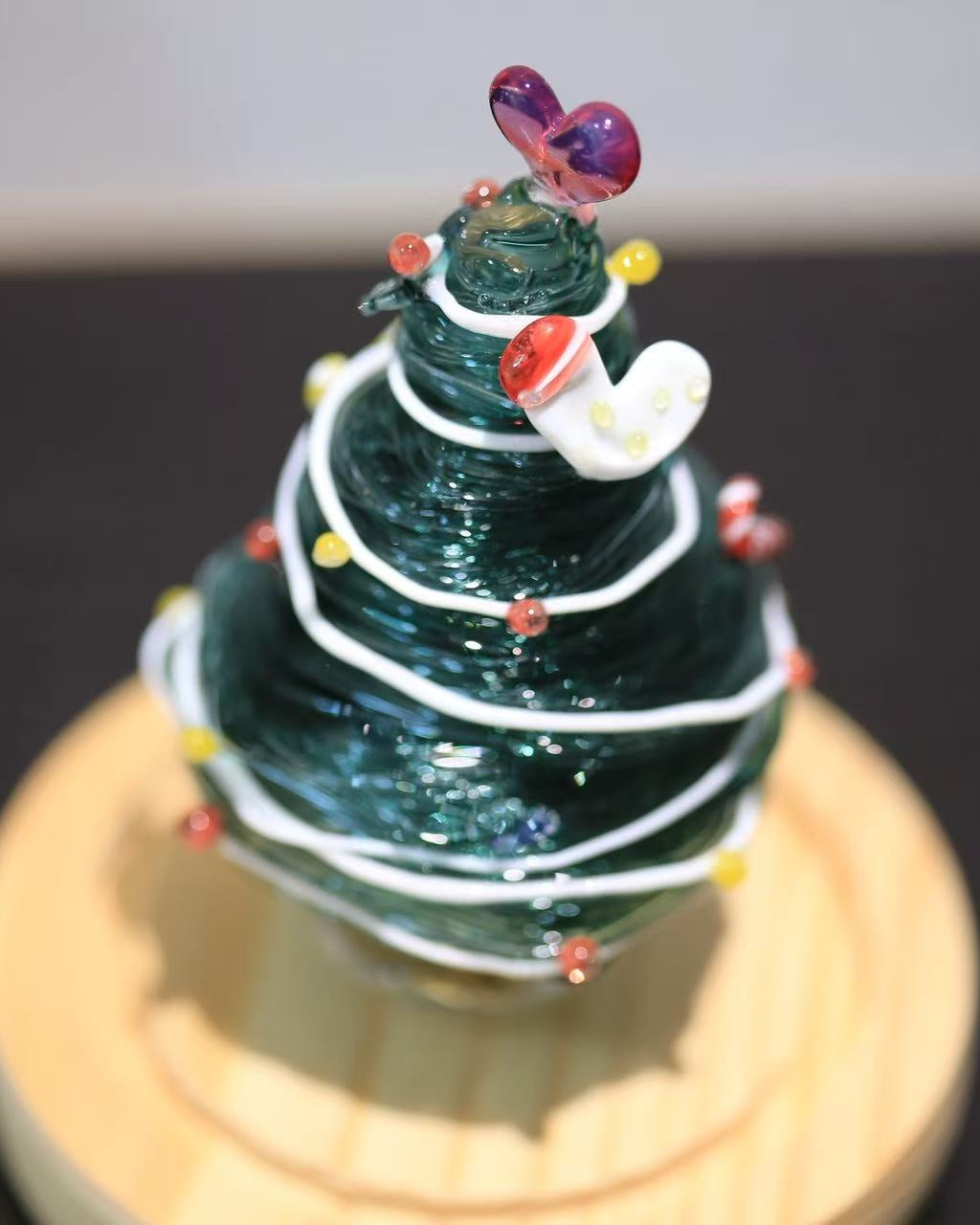 Hand-Lampworked green glass Christmas tree with white spiral, colorful dots and heart topper
