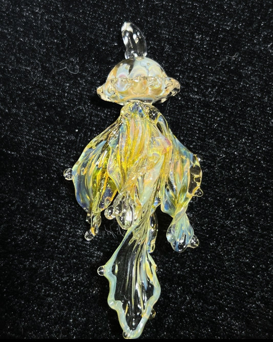 Ethereal hand-blown glass jellyfish pendant necklace by Ambero Oasis, featuring clear glass with amber and yellow internal details.