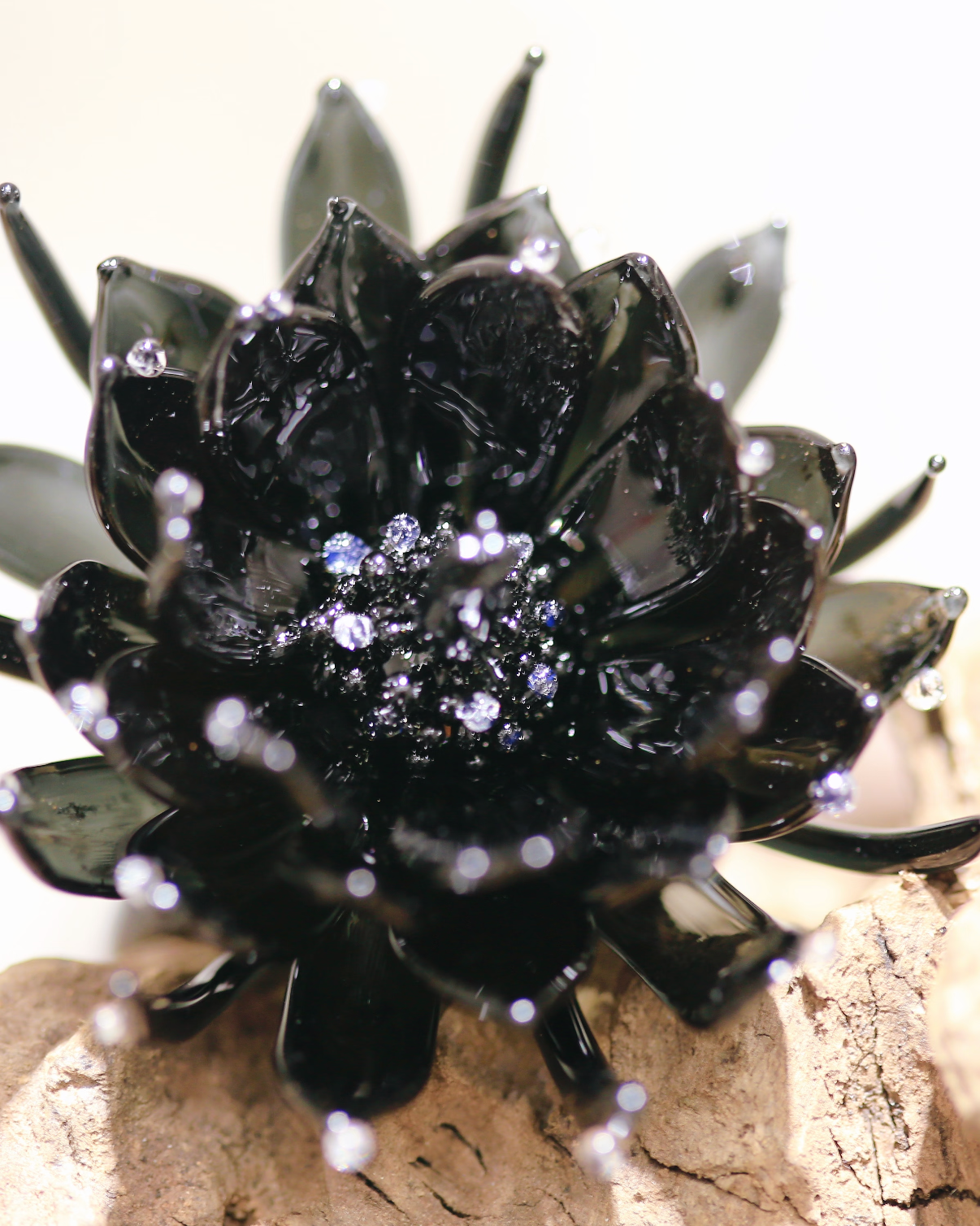 Front close-up of black epiphyllum lampwork glass ring showing layered petals