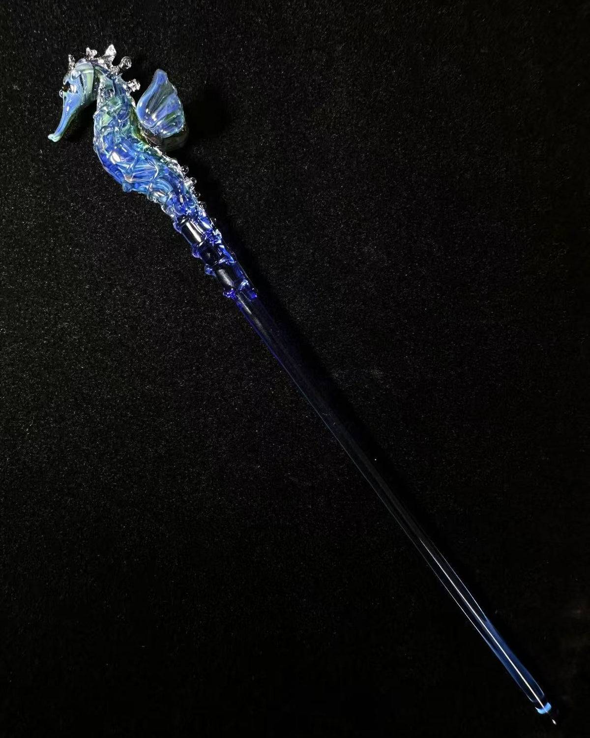  handmade lampwork glass seahorse drink stirrers, magical talisman barware, 18cm long, crossed display on dark background with botanical border.