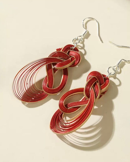 Bamboo Whisper handmade Chinese bamboo weaving dangle earrings by Ambero Oasis, featuring intricate red interlocking loops on silver hooks.