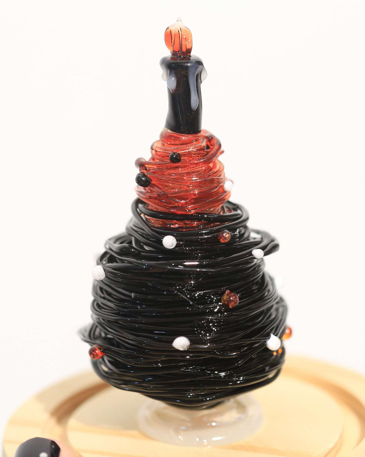 Black and red gradient glass Christmas tree with candle topper and wooden base