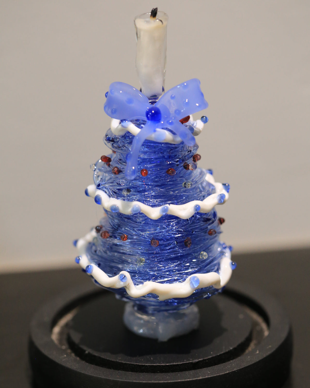 Blue gradient glass Christmas tree with candle topper and black base