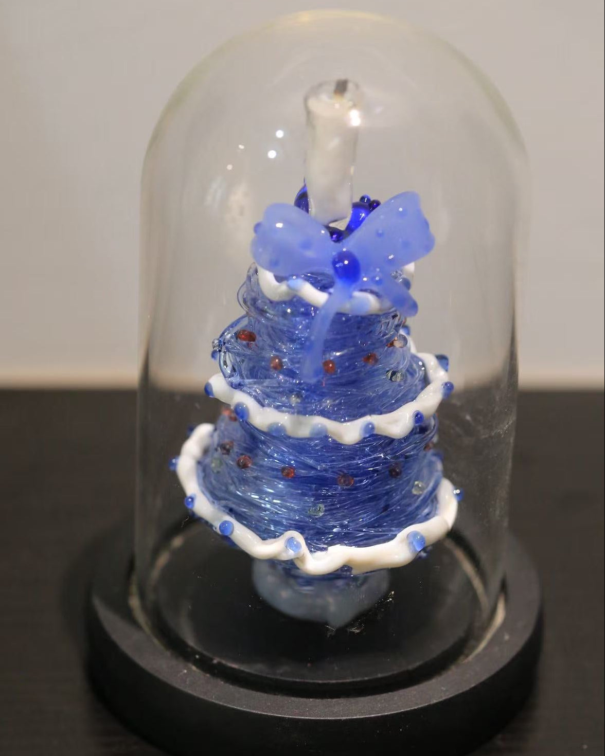 Blue gradient glass Christmas tree with candle topper and black base