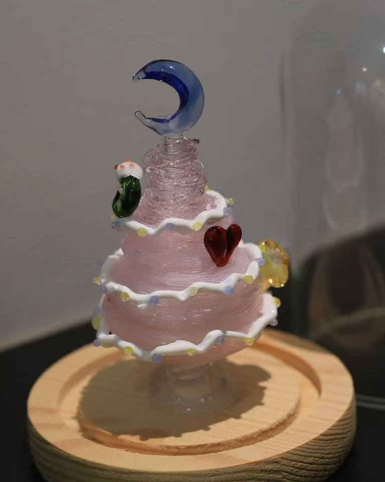 Pink gradient glass Christmas tree with blue moon topper and wooden base