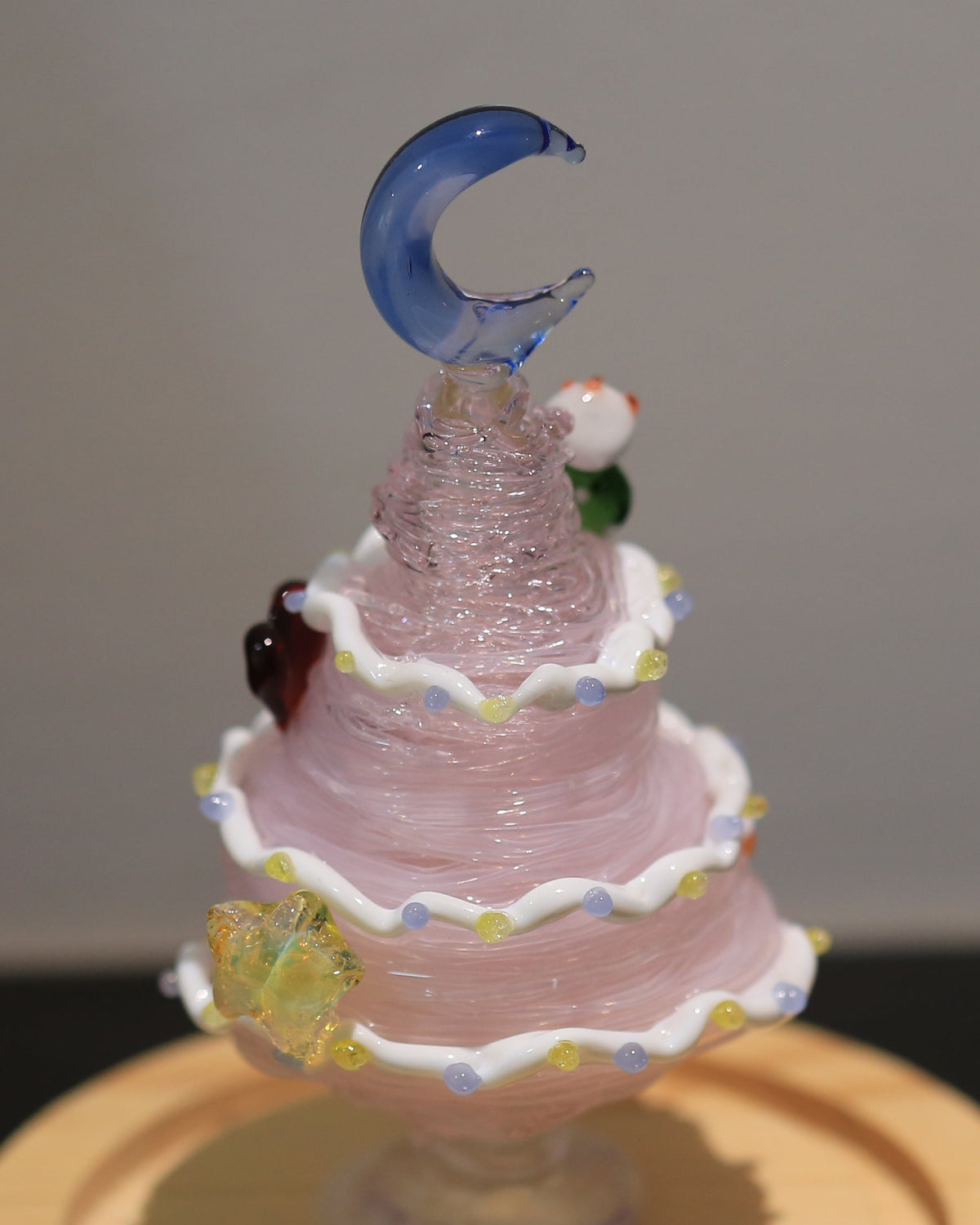 Hand-Lampworked pink glass Christmas tree with white ruffles, stars and blue moon topper