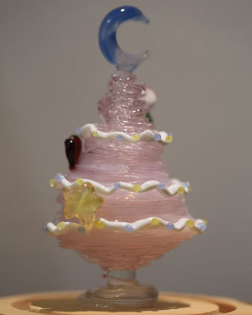 Pink gradient glass Christmas tree with blue moon topper and wooden base