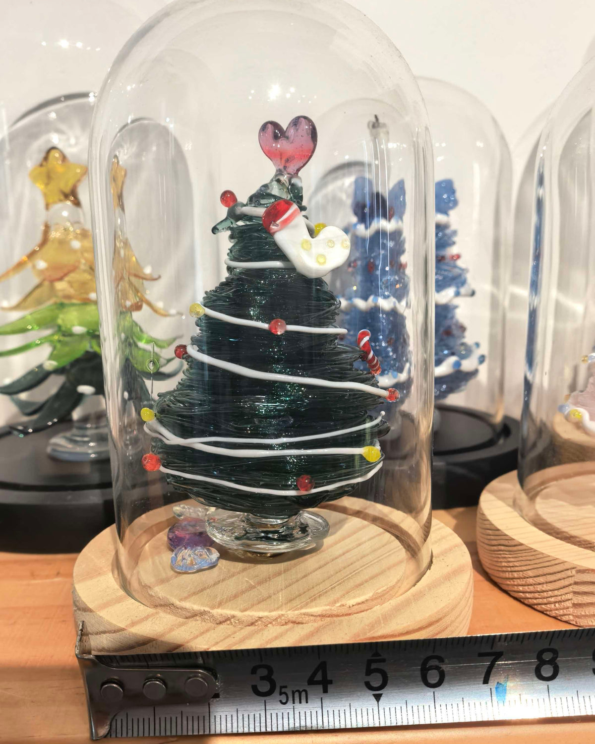 Green glass Christmas tree with glass dome and wooden base