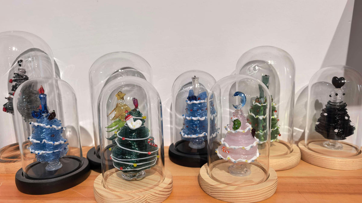 eight different glass Christmas trees