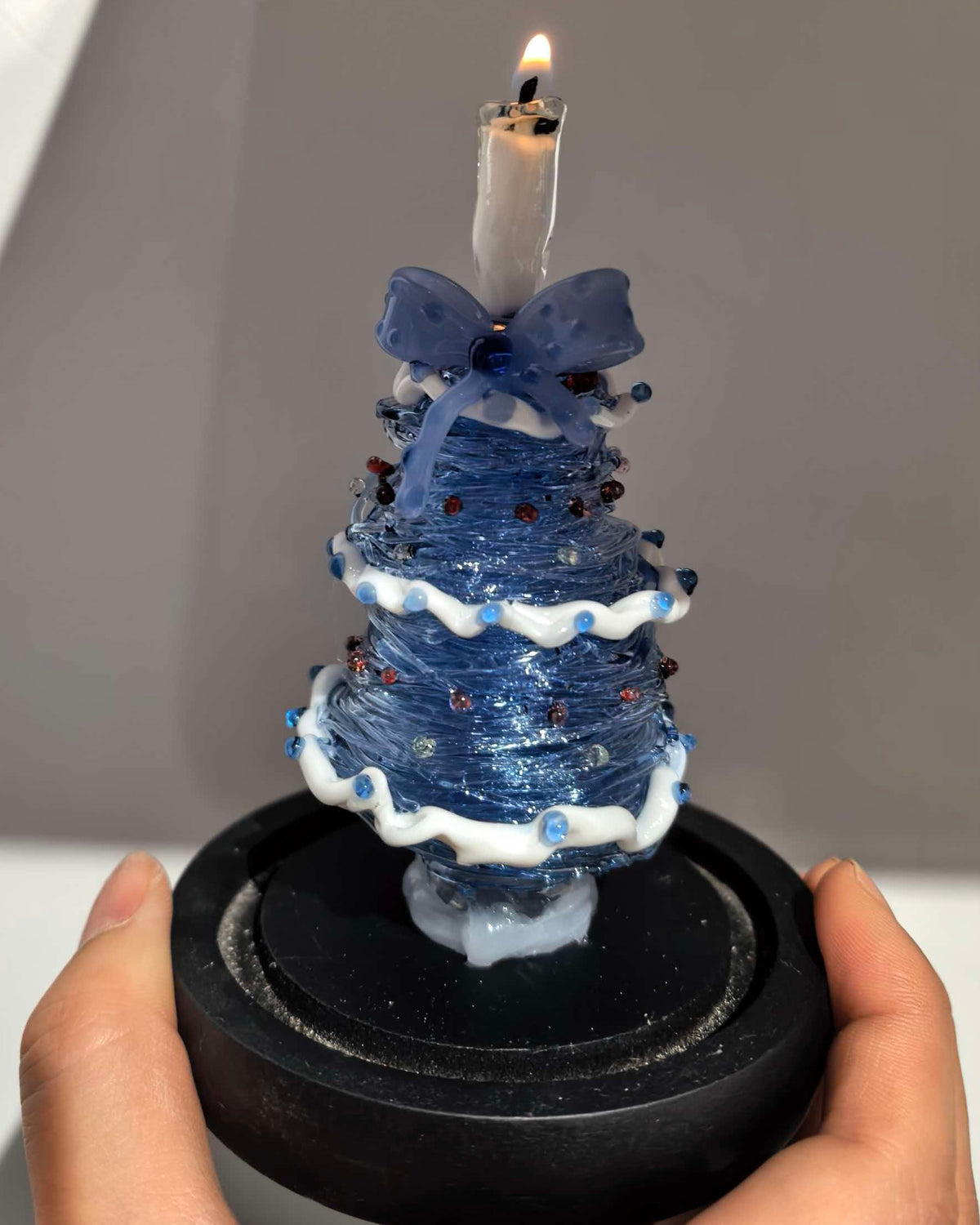 Blue gradient glass Christmas tree with candle topper and black base